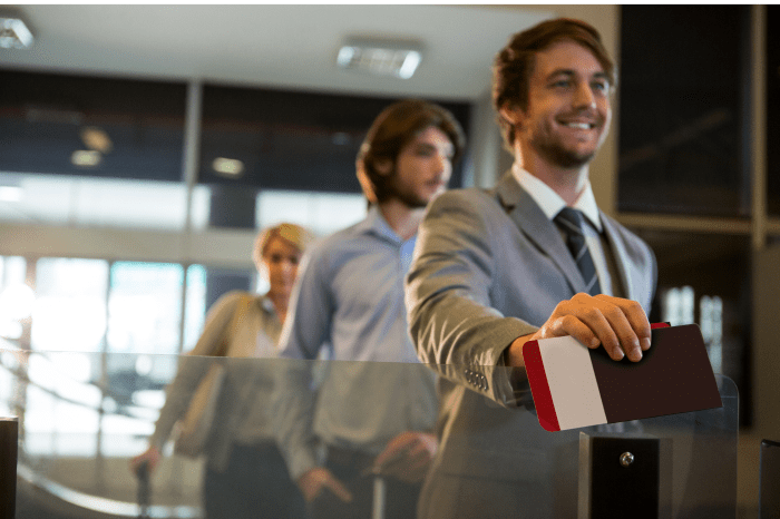 businessman-standing-with-boarding-pass-check-counter-1
